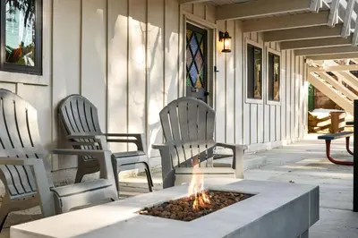 two chairs and a fire pit on a porch at Timber Wolf Tavern - Walk to Slopes, Game Room, Pool Table, BBQ in Big Bear Lake