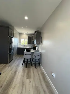 a kitchen with a counter and stools in a room at Vacation home in Westminster