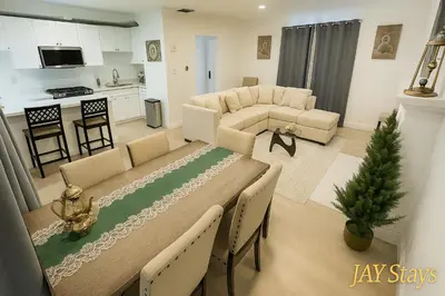 a living room with a dining table and a kitchen at Newly renovated, warm home with 4 bedrooms, 14 miles from Disney in Whittier