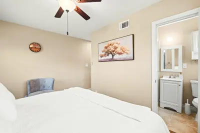 a bedroom with a white bed and a ceiling fan at Modern 4B Retreat with Cozy Decor in Upland