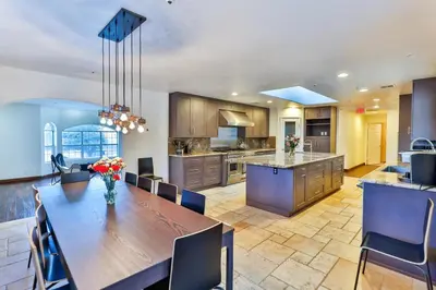 a kitchen and dining room with a large wooden table at Amazing Escape near LA Meditation Room, Game room, Hot Tub, Pool in Leona Valley