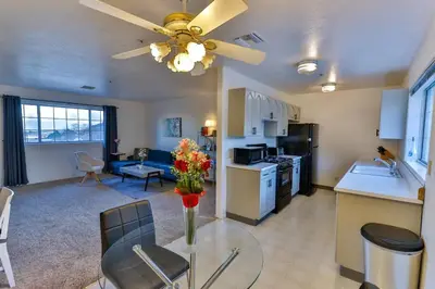 a kitchen and living room with a table and a ceiling fan at Amazing Escape near LA Meditation Room, Game room, Hot Tub, Pool in Leona Valley