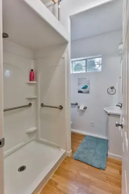 a white bathroom with a shower and a sink at Amazing Escape near LA Meditation Room, Game room, Hot Tub, Pool in Leona Valley