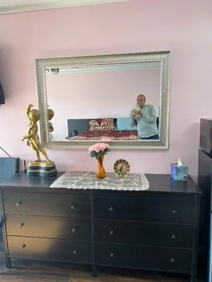 a man taking a picture in a mirror over a dresser at Pool Front Romantic Getaway withPrivate Entry in North Hills