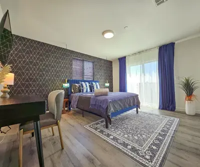 a bedroom with a bed and a desk and a piano at Forty First Place - Boutique Hostel in Los Angeles