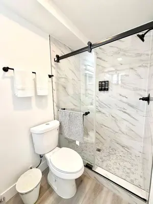 a bathroom with a toilet and a shower at GilmoreOne in Van Nuys