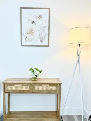 a desk with a lamp and a picture on the wall at GilmoreOne in Van Nuys