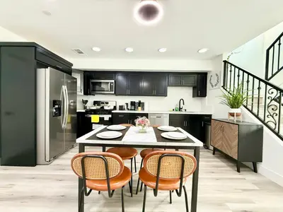 a kitchen with a table and chairs in a kitchen at GilmoreOne in Van Nuys
