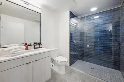 a bathroom with a toilet and a glass shower at Hollywood 1bdr apt with Pool, Free Parking, Gym in Los Angeles