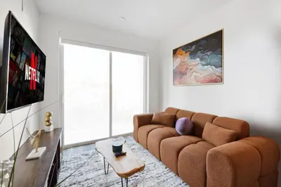 a living room with a couch and a large window at Hollywood 1bdr apt with Pool, Free Parking, Gym in Los Angeles