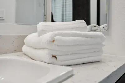 a stack of towels sitting on a counter in a bathroom at Spacious 1BDR near Walk of Fame with Luxury Amenities in Los Angeles