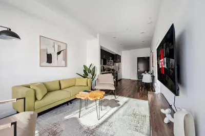 a living room with a yellow couch and a table at Spacious 1BDR near Walk of Fame with Luxury Amenities in Los Angeles