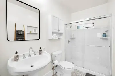 a bathroom with a sink and a toilet and a shower at Charming Craftsman Near DTLA in Los Angeles