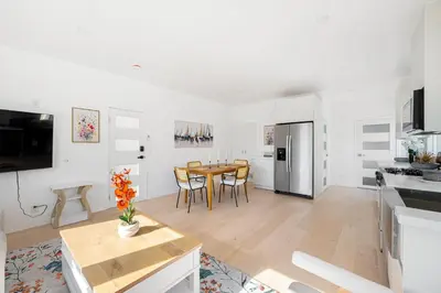 a kitchen and dining room with a table and chairs at Pacific Coast Suites - Oceanfront Living in Los Angeles