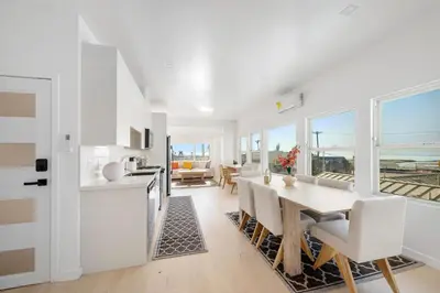 a kitchen and dining room with a table and chairs at Pacific Coast Suites - Oceanfront Living in Los Angeles