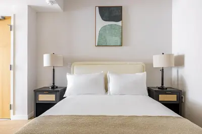 a bedroom with a white bed with two lamps at Blueground Downtown elevator nr parks LAX-1251 in Los Angeles