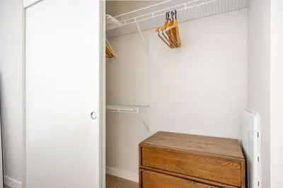a closet with a wooden dresser in a room at Blueground Downtown elevator nr parks LAX-1251 in Los Angeles