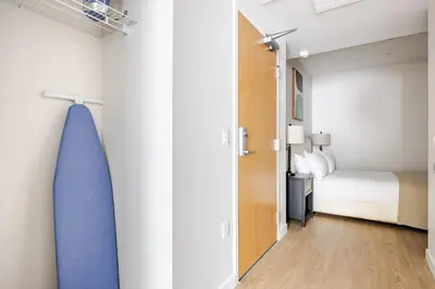 a bedroom with a bed and a room with a door at Blueground Downtown elevator nr parks LAX-1251 in Los Angeles