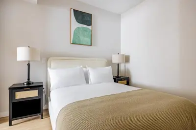 a bedroom with a large bed with two lamps at Blueground Downtown elevator nr parks LAX-1251 in Los Angeles