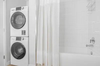 a washing machine and a washer in a bathroom at Blueground Downtown elevator nr parks LAX-1252 in Los Angeles