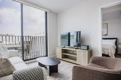 a living room with a couch and a tv at Blueground Downtown AC elevator nr parks LAX-1253 in Los Angeles