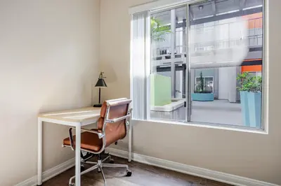 an office with a desk and a window at Blueground Glendale pool AC nr Americana LAX-1319 in Glendale