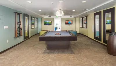 a large room with a pool table in it at Blueground Glendale pool AC nr Americana LAX-1319 in Glendale