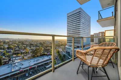 a balcony with a chair and a view of a city at The Sky Gem in Los Angeles