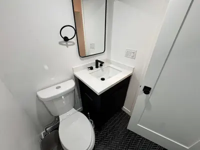 a bathroom with a white toilet and a sink at Los Angeles Central Town House in Los Angeles
