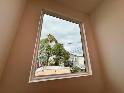 a window in a room looking out at a house at Los Angeles Central Town House in Los Angeles