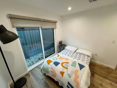a bedroom with a bed and a large window at Los Angeles Central Town House in Los Angeles