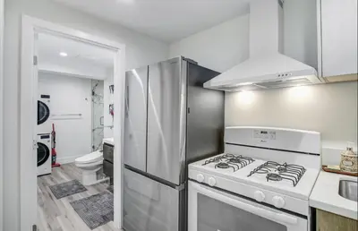 a kitchen with a white stove and a refrigerator at Wellness Temple LA in Tarzana