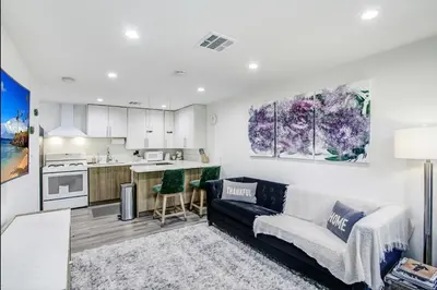 a living room with a couch and a kitchen at Wellness Temple LA in Tarzana