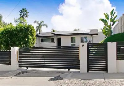 a black and white fence in front of a house at Wellness Temple LA in Tarzana