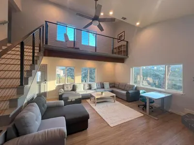 a living room with a couch and a staircase at Rancho del Cielo in Twin Lakes