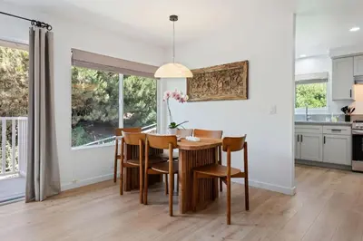 a kitchen and dining room with a table and chairs at Coastal Living and Family Friendly in Summerland