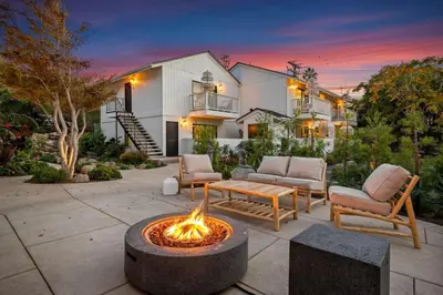 a backyard with a fire pit in front of a house at Coastal Living and Family Friendly in Summerland