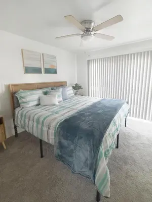 a bedroom with a bed with a ceiling fan at Quaint Mid-Century Cottage by the Coast in Ventura