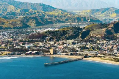 an aerial view of a beach with a city and mountains at Quaint Mid-Century Cottage by the Coast in Ventura