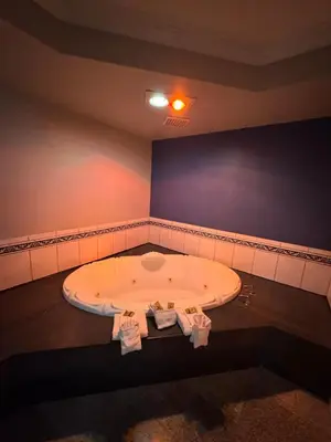 a bathroom with a large bath tub in a room at Sunset Inn & Suites in Gardena