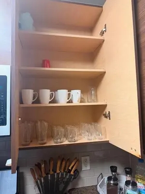a kitchen shelf with cups and bowls on it at Villa Marina - AMAZING Modern, Spacious, Stylish 2 Master Suites in CENTRAL Marina Del Rey in Los Angeles