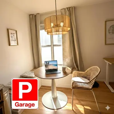 a table with a laptop on it in a room at Boho 1-Bedroom BEACH Condo with Mid Size Parking, AC & Laundry - Walk 10min to BEACH! in Long Beach