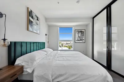 a bedroom with a large white bed and a window at Hollywood 1bdr Comfort with Pool, Gym, Free Parking in Los Angeles