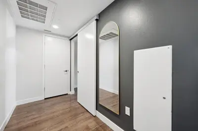 a hallway with white and gray walls and a mirror at Hollywood 1bdr Comfort with Pool, Gym, Free Parking in Los Angeles