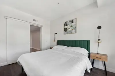 a bedroom with a white bed and a green headboard at Hollywood 1bdr Comfort with Pool, Gym, Free Parking in Los Angeles