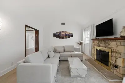 a living room with a couch and a fireplace at Spacious 4BR House with Large Yard and Parking Beverly Hills Adj in Los Angeles
