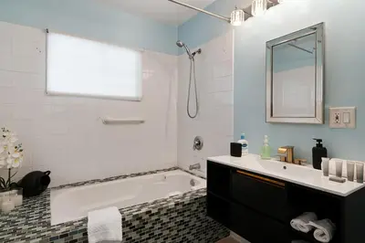 a bathroom with a tub and a sink at Spacious 4BR House with Large Yard and Parking Beverly Hills Adj in Los Angeles