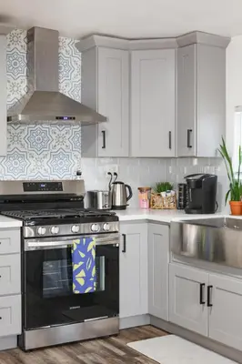 a kitchen with white cabinets and a black oven at Central Modern All-In-One Home in Lakewood