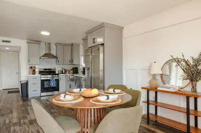 a kitchen with a table and chairs in a room at Central Modern All-In-One Home in Lakewood