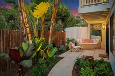 a patio with a couch and some plants at Private Garden and Family Friendly in Summerland